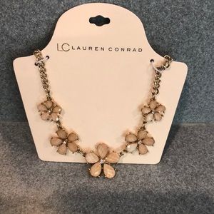 Gold toned floral necklace with iridescent petals